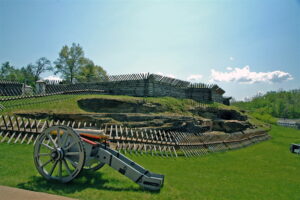 cannon in front of wooden fort